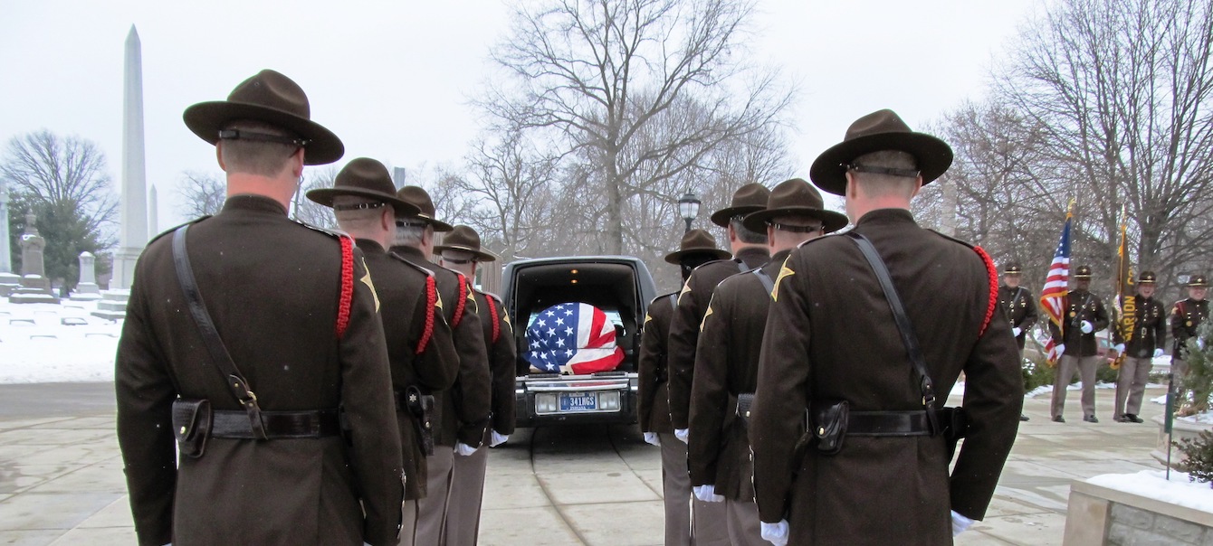 Honor Guards lined up behind hearse.