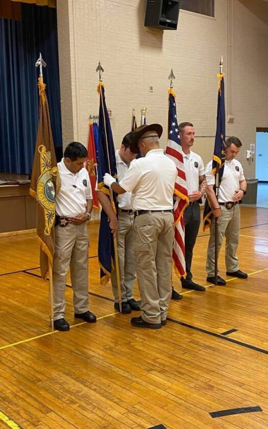 Young men with training with flags at Youth Leadership Camp.