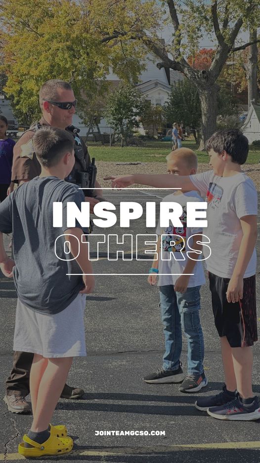 Officer with teenage boys. "Inspire others".